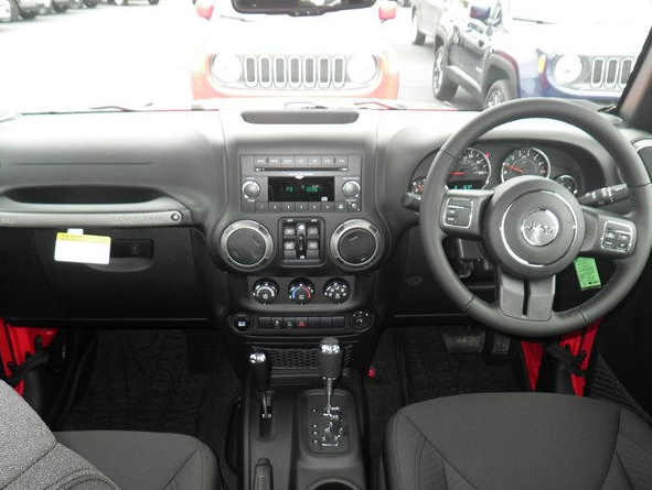 right hand drive vehicle on roadway with trees and falling leaves